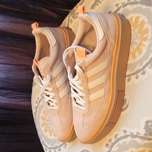 Tan and orange Adidas